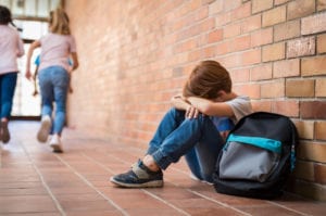 upset child, school bullying concept